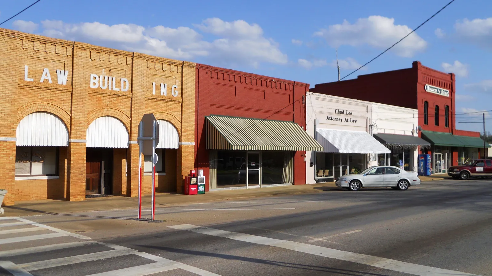 Brick storefronts with striped awnings along Main Street in downtown Wedowee, Alabama